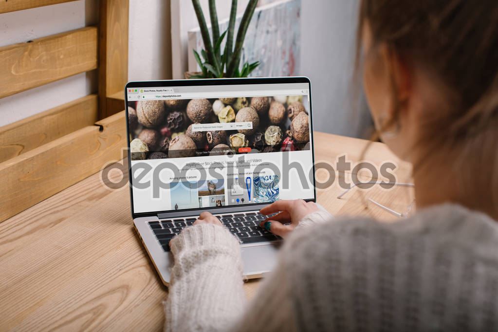 cropped image of girl sitting with laptop with loaded depositphotos page